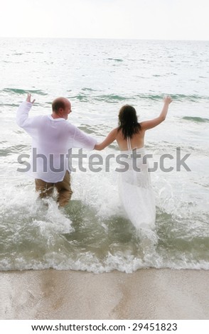 Gorgeous bride and groom on the beach - tropical destination wedding.