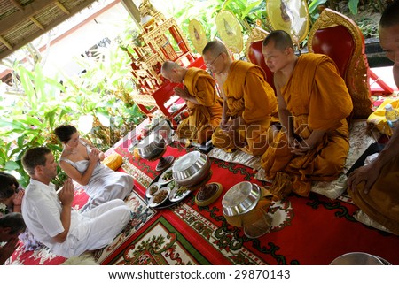 KOH LANTA - DECEMBER 2: Western couple gets married during a traditional Buddhist wedding on December 2, 2008 in Koh Lanta, Thailand.
