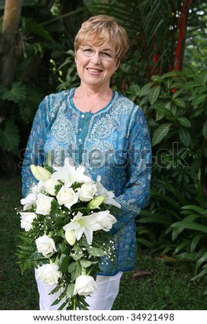 Mature bride with a bouquet of flowers.