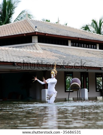 PHUKET - AUGUST 19: Traditional Thai dancer performs a ceremony in the water on August 19, 2009 in Phuket, Thailand.