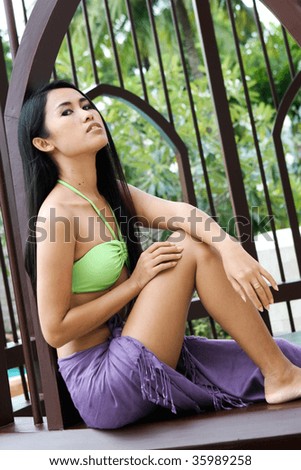 Beautiful Asian woman wearing a bikini and sarong.