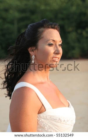 Beautiful bride on the beach - tropical destination wedding.