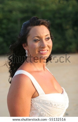 Beautiful bride on the beach - tropical destination wedding.
