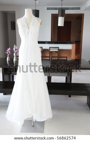 stock photo Beautiful white lace and silk wedding dress on a mannequin