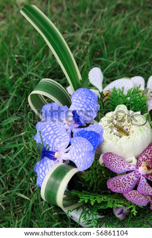 stock photo Silver wedding rings set on a colorful floral arrangement
