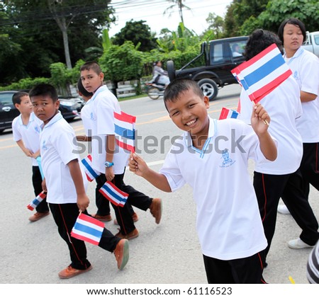 stock photo : PHUKET - SEPTEMBER 16: unidentified students during a parade marking the birthday of monk  Luang Pu Supha who is 114 on September 16, 2010 in Phuket, Thailand. Many Thais believe he is the world's oldest man.