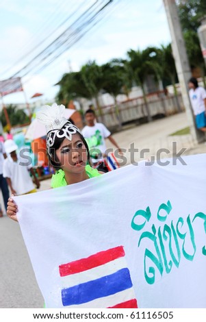 PHUKET - SEPTEMBER 16: unidentified student during a parade marking the birthday of monk  Luang Pu Supha who is 114 on September 16, 2010 in Phuket, Thailand. Many Thais believe he is the world\'s oldest man.