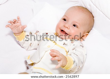 the baby lies on white pillow