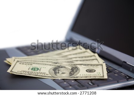 the some US dollars banknotes on laptop