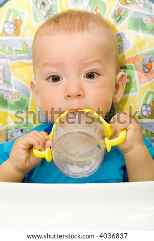 the small boy to sit still with cup