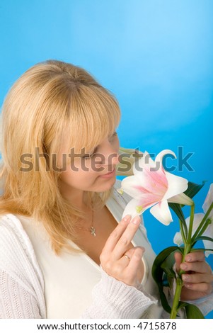 the young blond woman with madonna lily on blue background