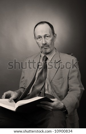 senior man with book, black and white, sepia