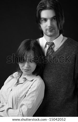 young couple isolated on black background, black and white