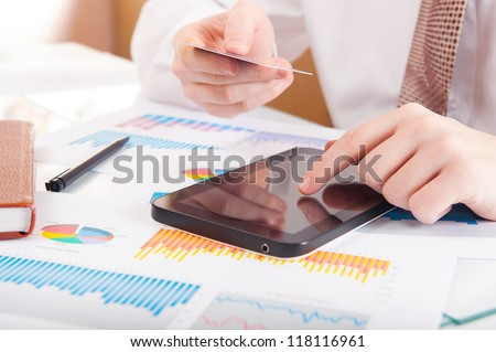 Businessman using a credit card and digital tablet for buying on-line