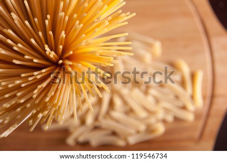 Spaghetti pasta over wooden background. View from above