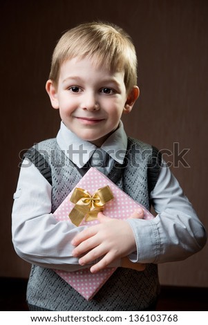 Cute little boy holding dotted present boy for Mother\'s Day
