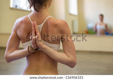 Beautiful young woman doing yoga exercise - Meditating