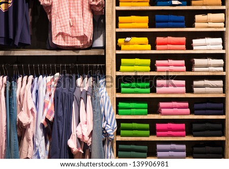 Various color shirts at shelf in shop