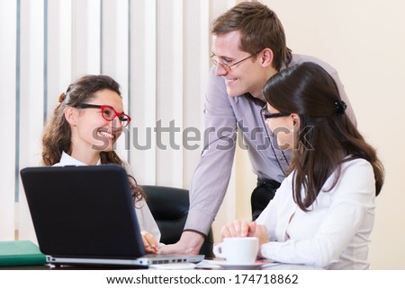 Three young executives working at modern office