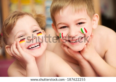 Cute little children couple with European flags on cheeks