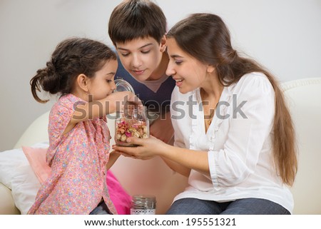 Happy mother with her little children at home