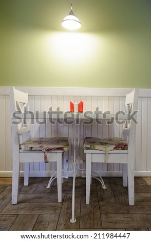 Table for two in cozy cafe with pastel green walls