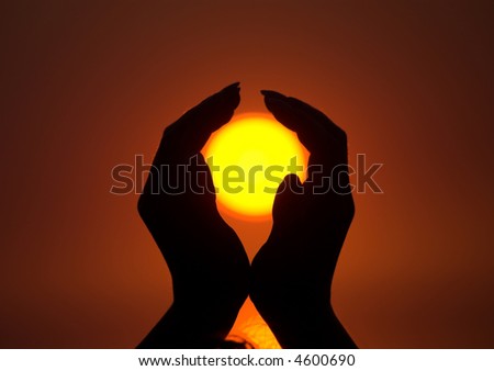 Sun in beautiful female hands during sunrise