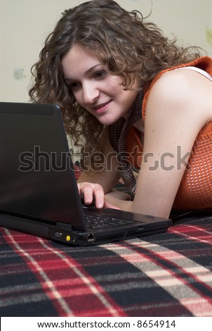 Young female is preparing for the lesson using laptop