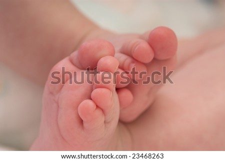 Cute feet of small baby. Shallow depth of field.