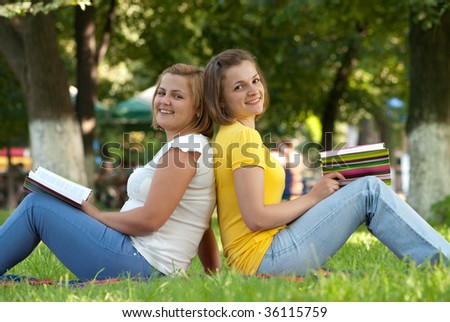 Two female students studying at campus park