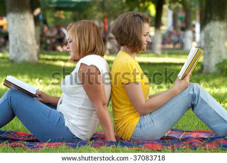 Two female students studying at campus park