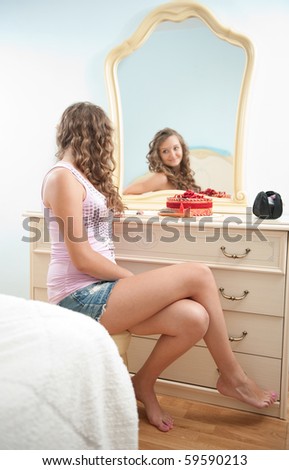 Young female in front of mirror in bedroom