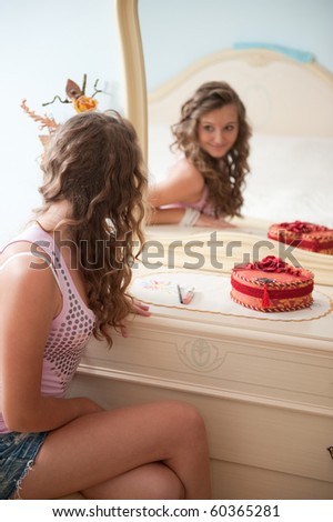 Young female in front of mirror in bedroom