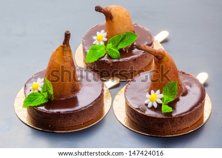 Three chocolate cakes with pear