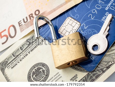 Credit card with chip, money, padlock and key.