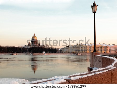 St. Isaac\'s Cathedral - view across the Neva River from the Vasilievsky Island. Russian winter. Twilight.