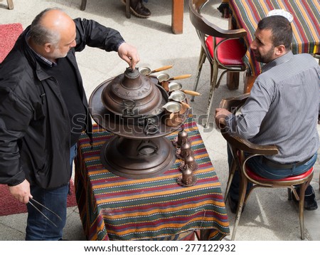 Istanbul, Turkey - April 25 2015. 
Coffee House in Istanbul. Preparation of Turkish coffee in the pot for the client. on April 25, 2015 in Istanbul, Turkey.