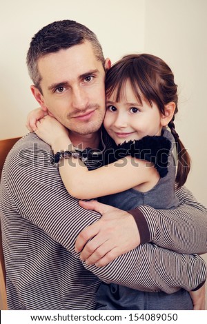 Father and daughter hugging and smiling