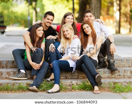 Group of six young student friends outdoors