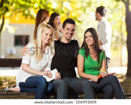 Group of young student friends sitting outdoors