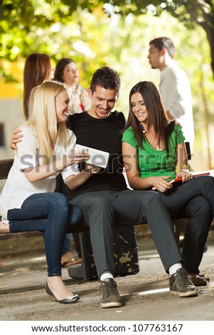 Group of young student friends sitting outdoors