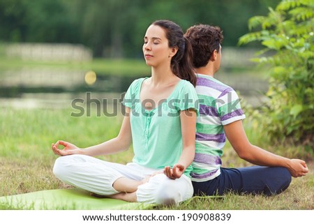 Young couple relaxing in yoga pose