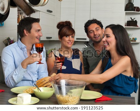 Girl serving pasta to her friends