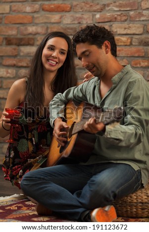 Couple relaxing with wine and music.