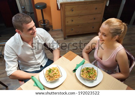 Young couple having pasta for dinner ina a restaurant.