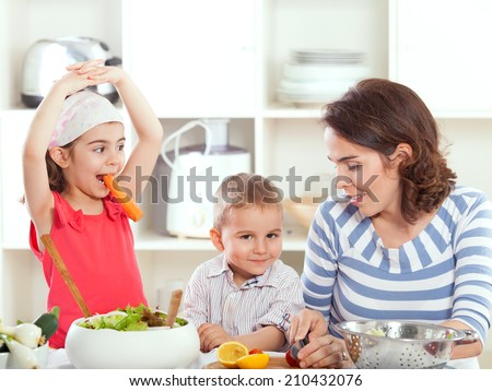 Kids having fun with mother in the kitchen