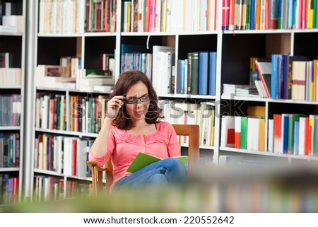 Beautiful woman relaxing with a good book.