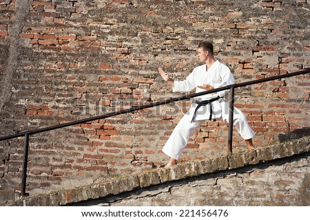 Man practicing martial arts in old town
