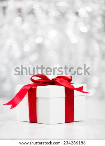 Christmas Gift packed in white box with red ribbon