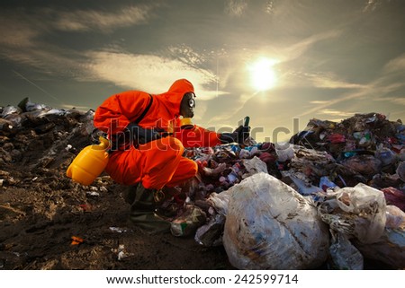 Sanitation worker measuring pollution on the landfill